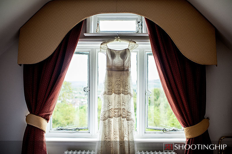 wedding dress hanging in window