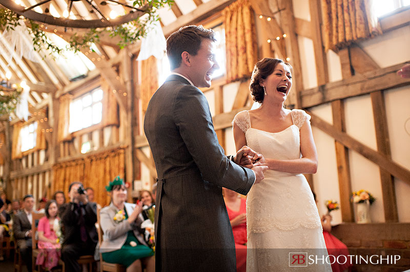 bride and groom laughing during wedding ceremony