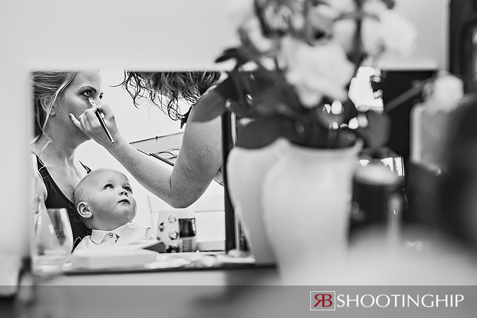 A little boy watches his mum get ready for the wedding