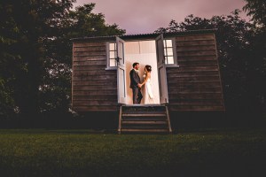 Bride and Groom in Shepherds hut at Tithe Barn