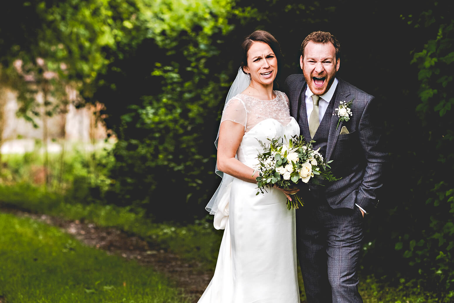 Bride and Groom laughing at Tithe Barn