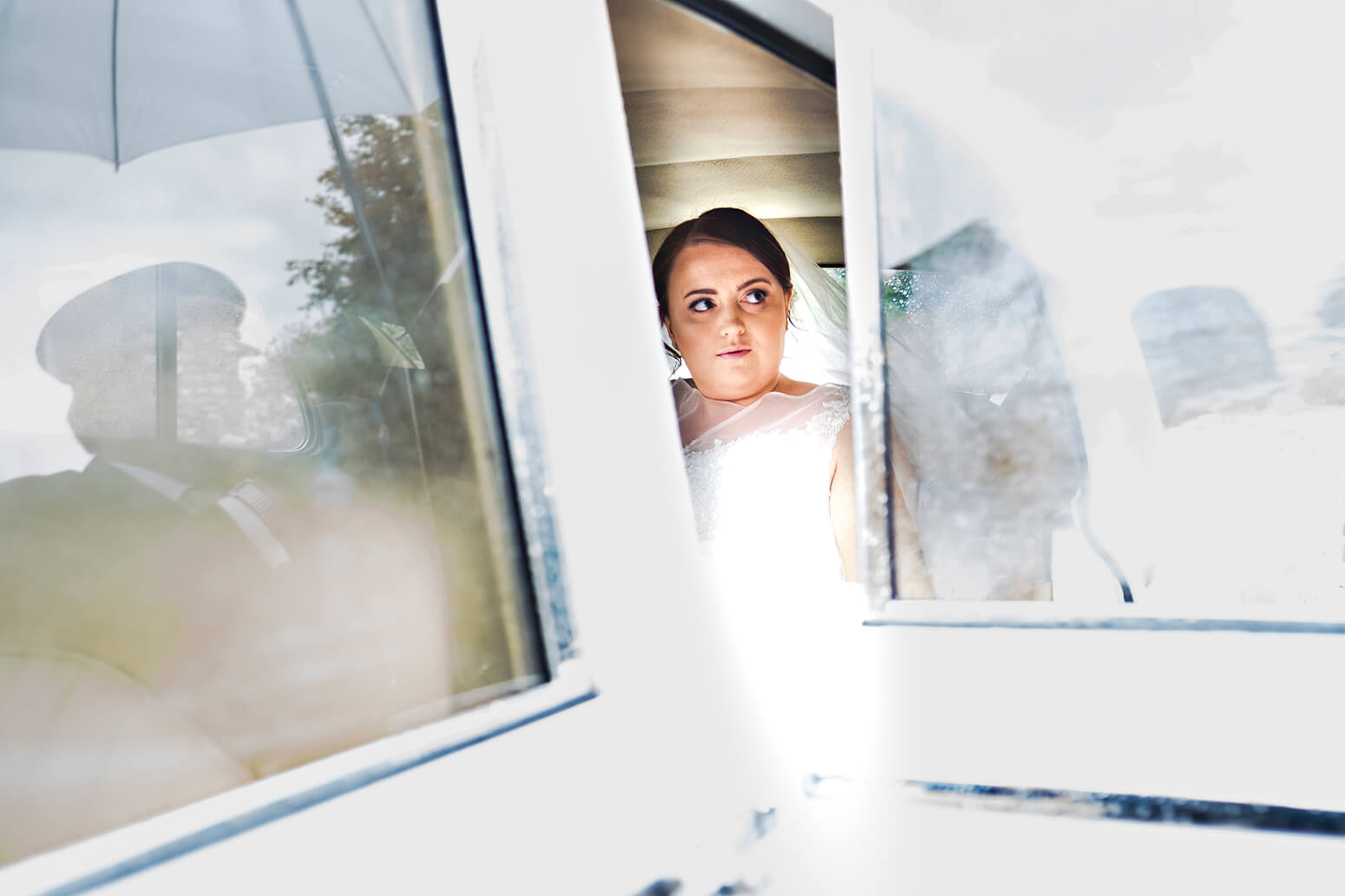 Bride in wedding car at Tithe Barn