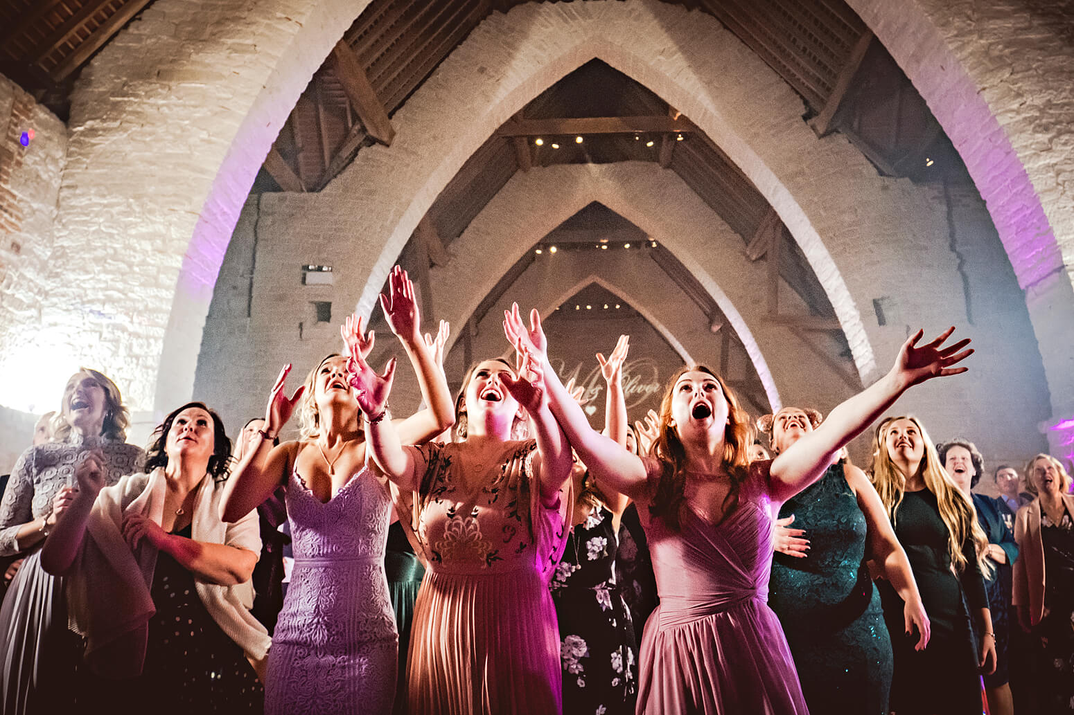 Bridal bouquet toss at Tithe Barn