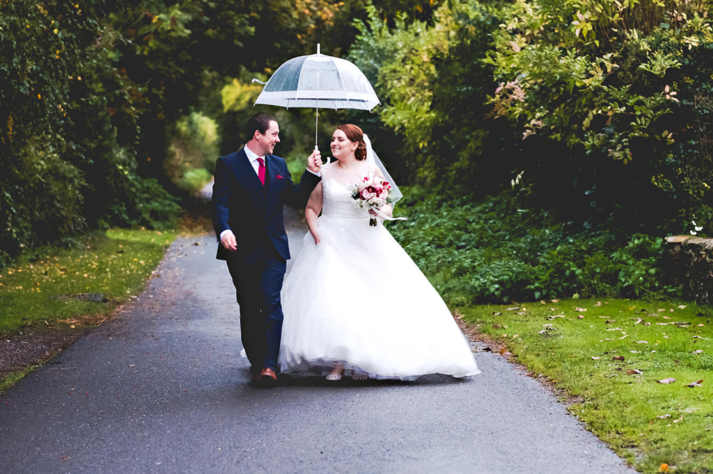 Couple in rain at Tithe Barn