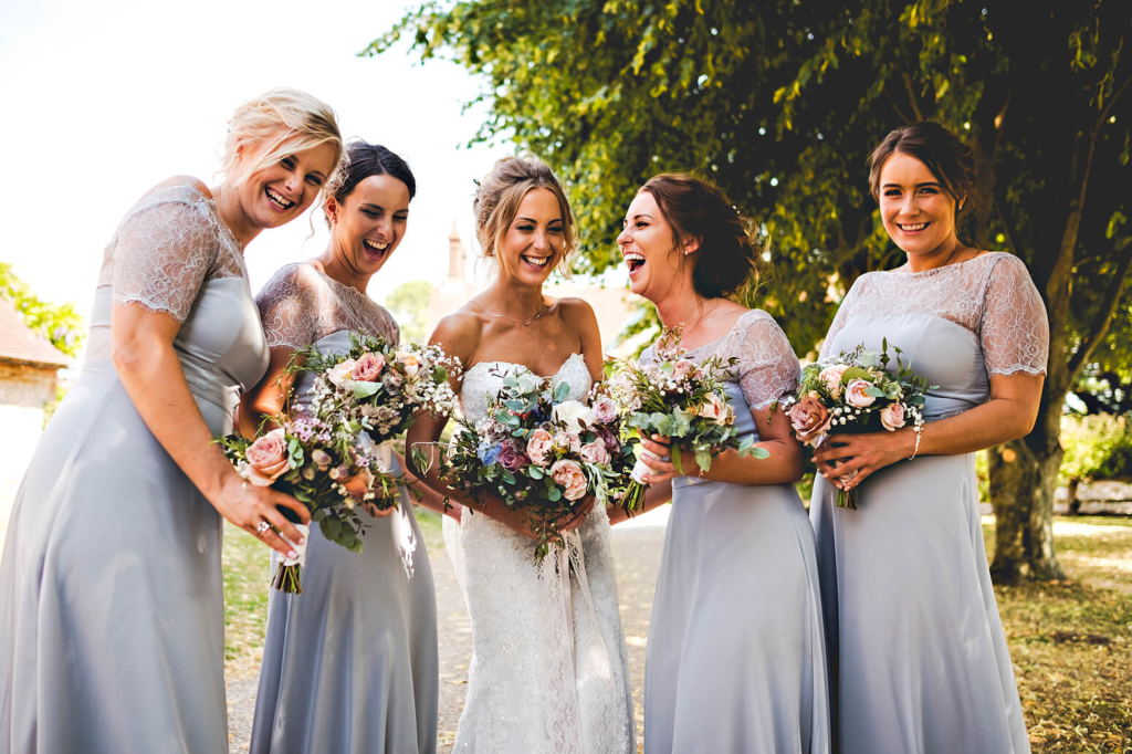 Bridesmaids laughing at Tithe Barn