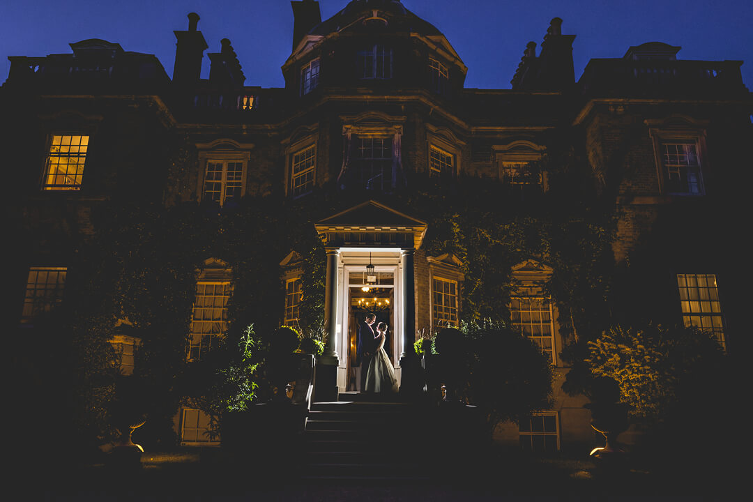 Dramatic photo of bride and groom at hampton court house