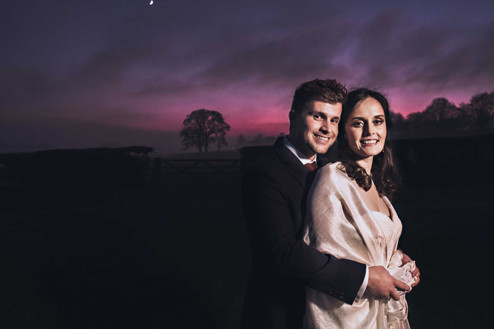 Dramatic sunset for Bride and Groom at Farbridge Barns