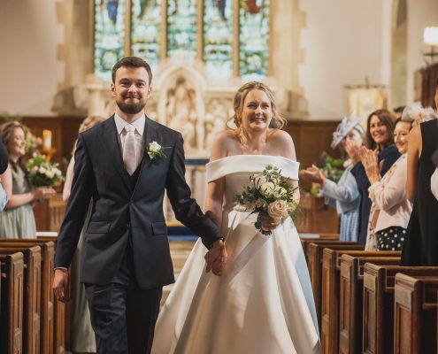 Giddy couple leaving the church